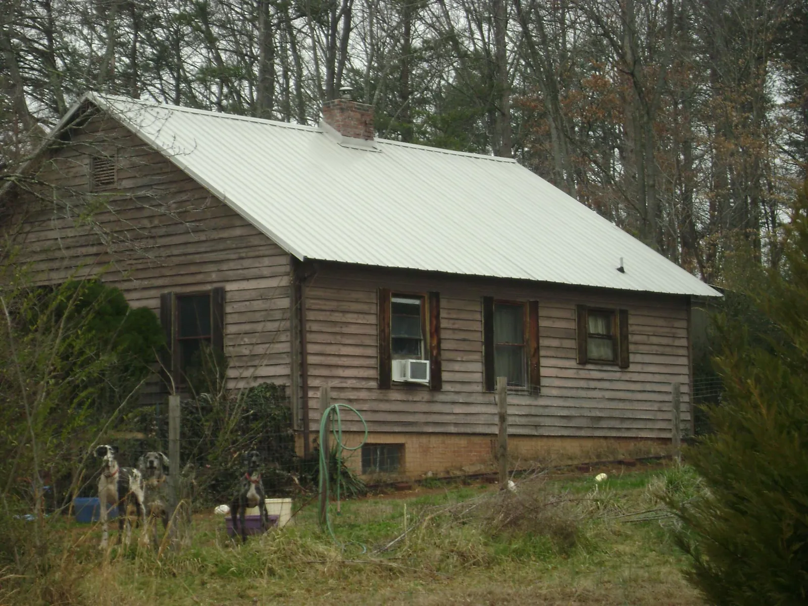 White metal roof on an old wood sided farmhouse, from a Asphalt Shingle Roof Repair job in Millerstown